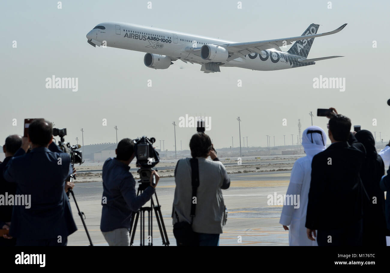 Doha, Qatar. 27th Jan, 2018. Journalists and cameramen record an Airbus A350-1000 jet at Doha International Airport in Doha, capital of Qatar, on Jan. 27, 2018. The brand new aircraft arrived in Doha as part of its demonstration tour to 12 Middle East and Asian-Pacific destinations. Credit: Nikku/Xinhua/Alamy Live News Stock Photo