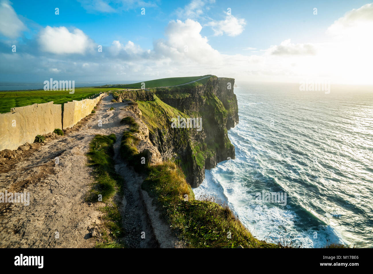 Coastal footpath walk on the Cliffs of Moher, Irelands Most Visited Natural Tourist Attraction, are sea cliffs located at the southwestern edge of the Stock Photo