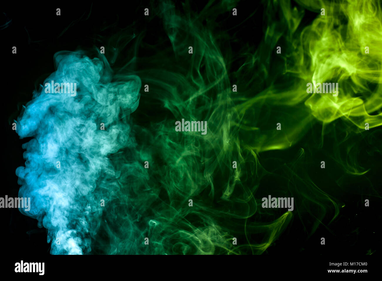Colorful green and blue smoke clouds on dark background Stock Photo - Alamy