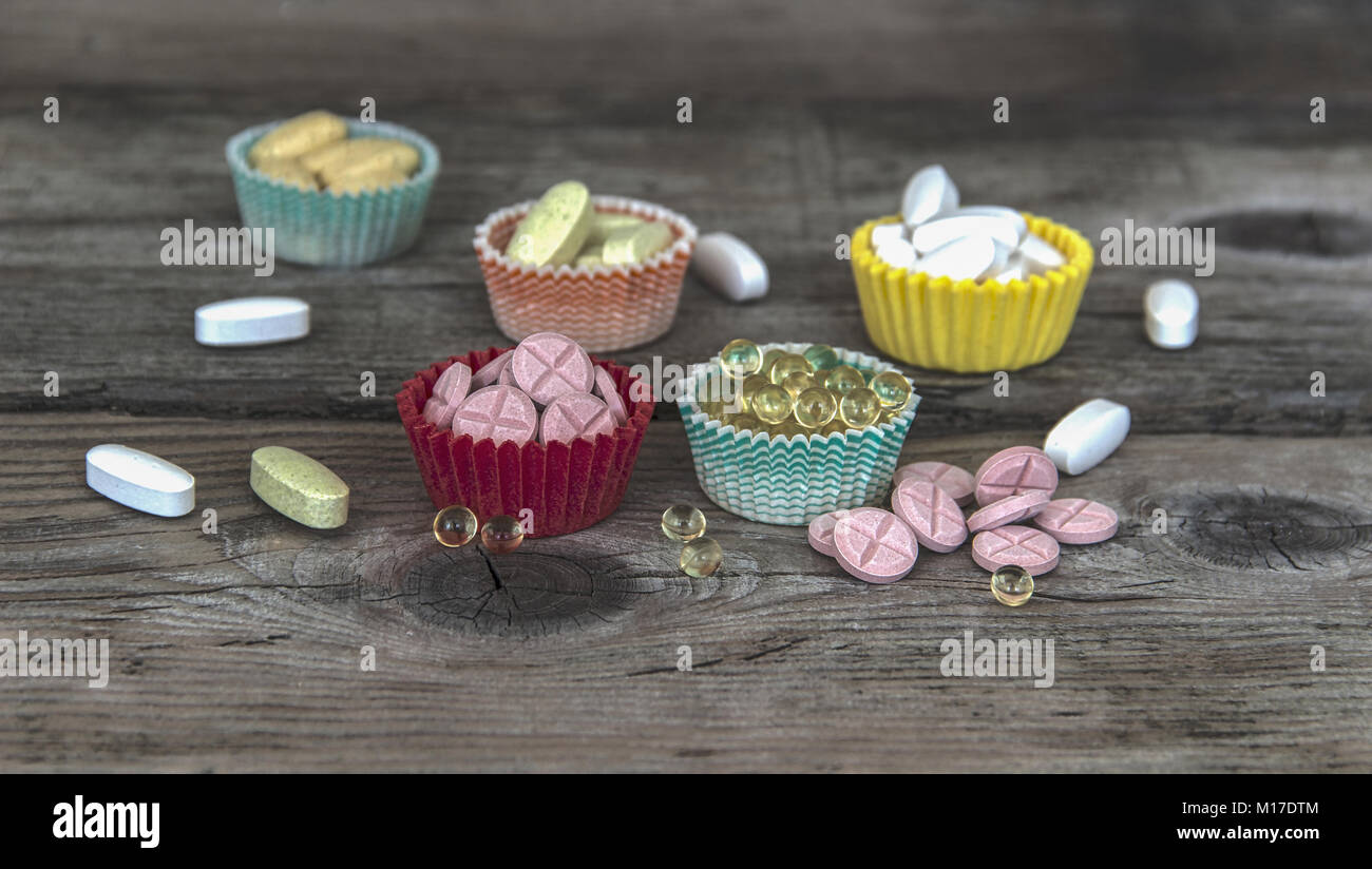 Several types of pills served in cake paper cups Stock Photo