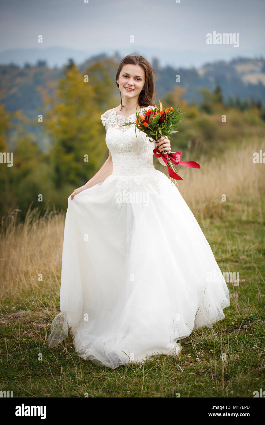 A Woman in a Wedding Gown Posing beside a Lamp Post · Free Stock Photo