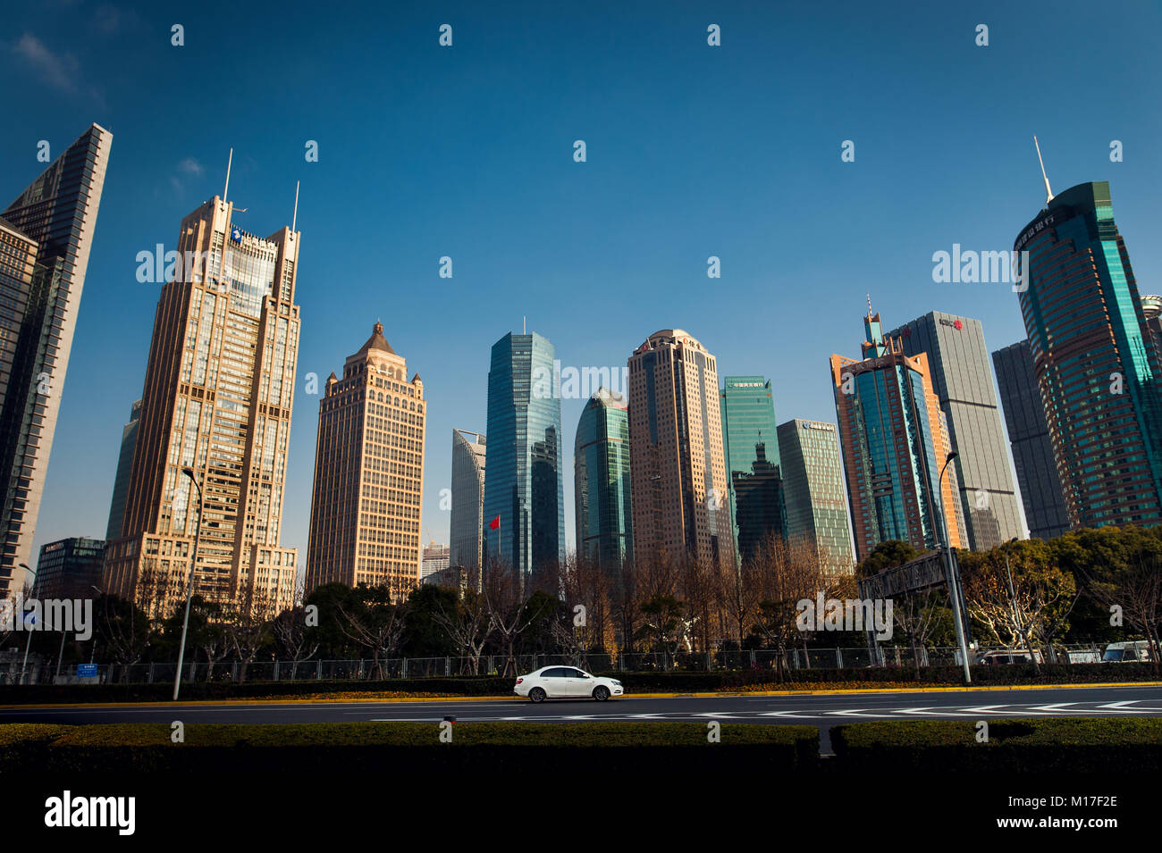 white car in front of Shanghai skyscrapers under blue sky Stock Photo