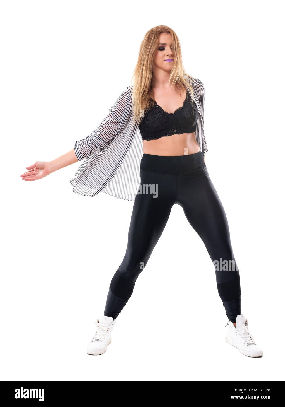 Active young sporty aerobics jazz dance instructor dancing and moving arms. Full body length portrait isolated on white studio background. Stock Photo