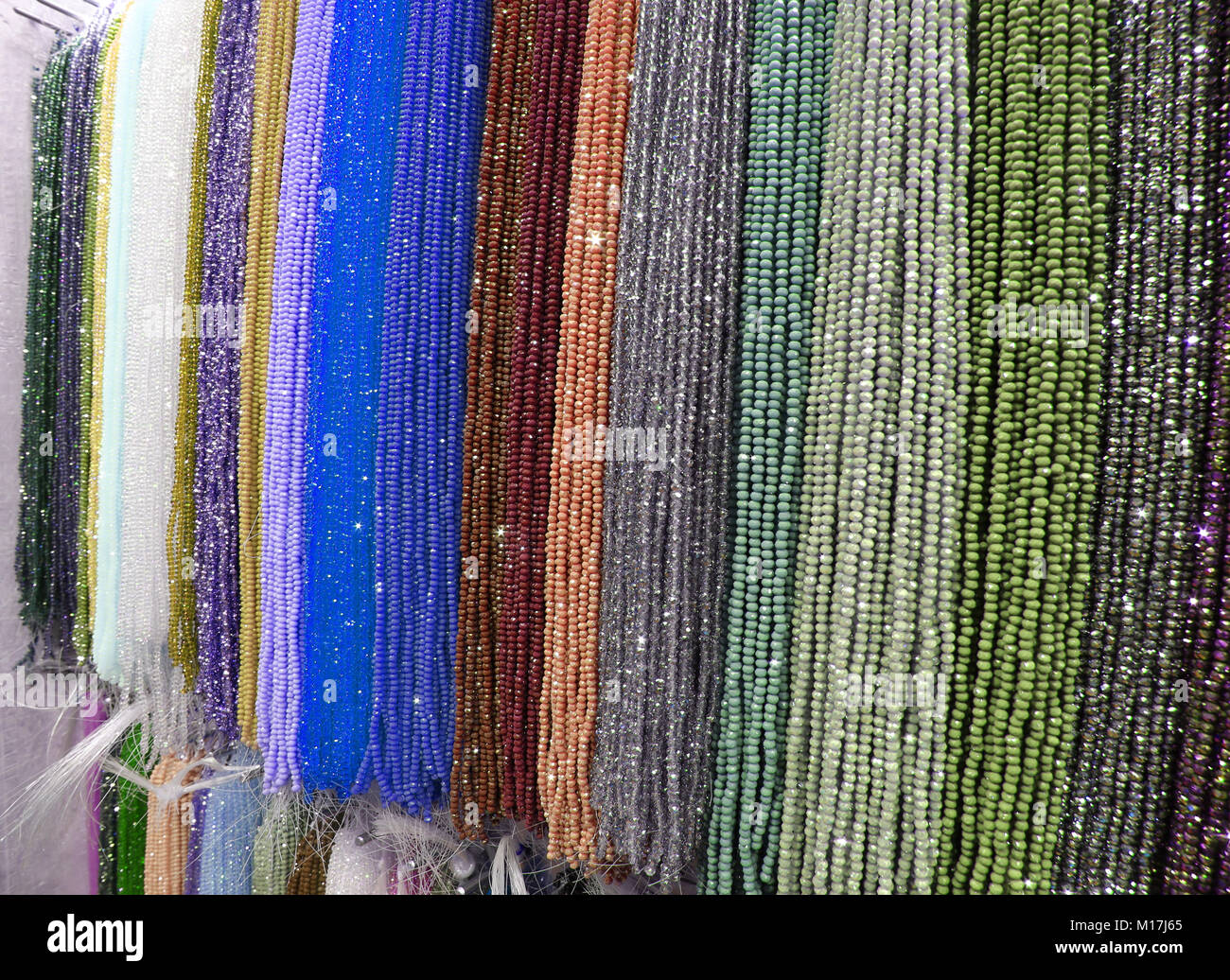 Many necklaces with beads on sale in a shop