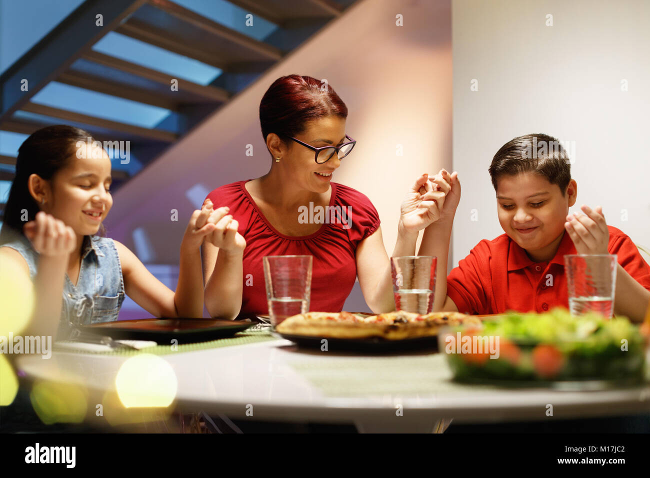 Family praying together hi-res stock photography and images - Alamy