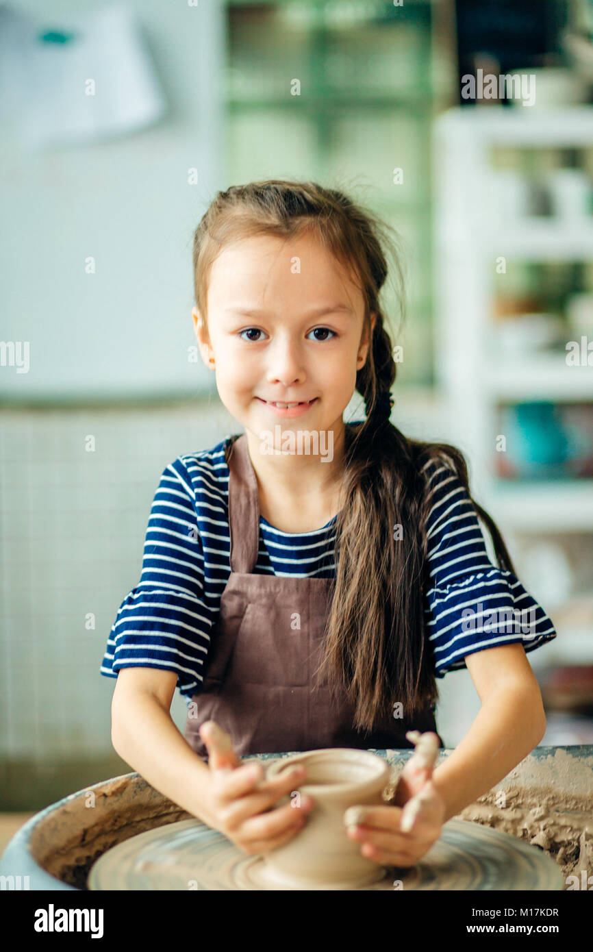 Child sculpts from clay pot. modeling on potter wheel Stock Photo Alamy