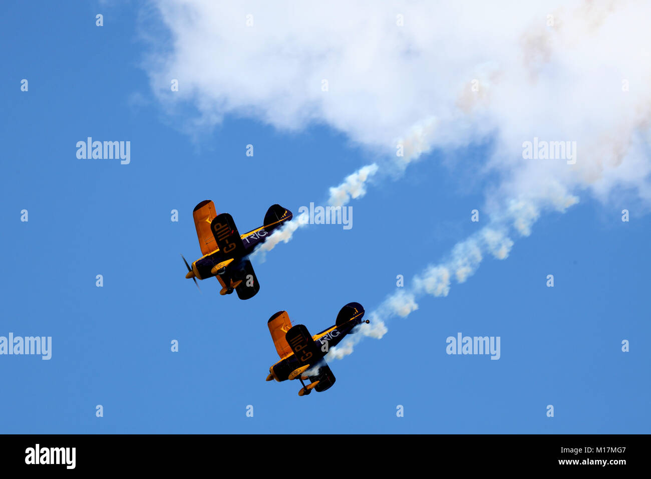 two biplanes emerge from a cloud whilst taking part in a display during scotland's national airshow held at the national museum of flight east fortune Stock Photo