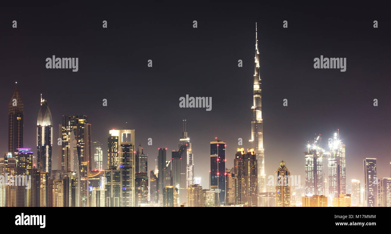 Illuminated Dubai Skyline At Night Against Sky Stock Photo - Alamy