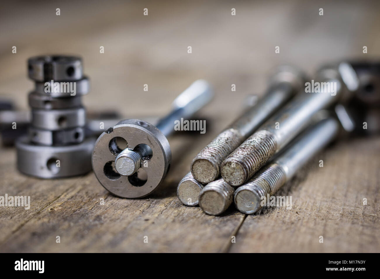 Metalwork tools on the table. Threading dies and taps in an