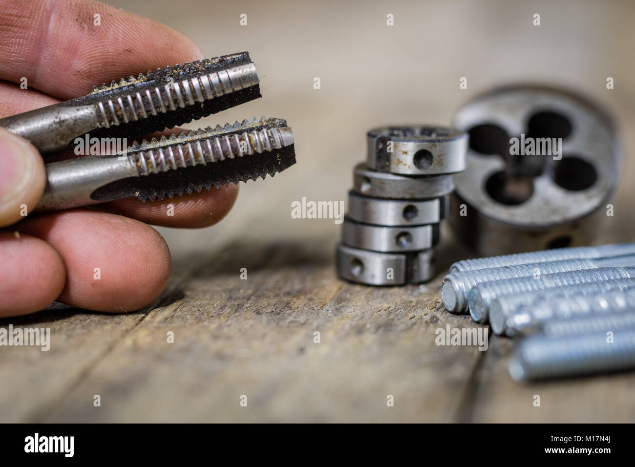 Metalwork tools on the workshop table. Threading dies and taps in an ...