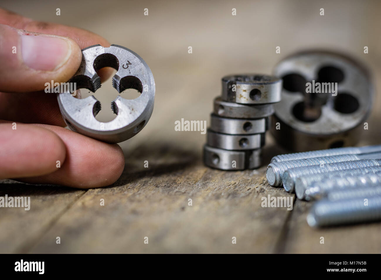 Metalwork tools on the workshop table. Threading dies and taps in an ...