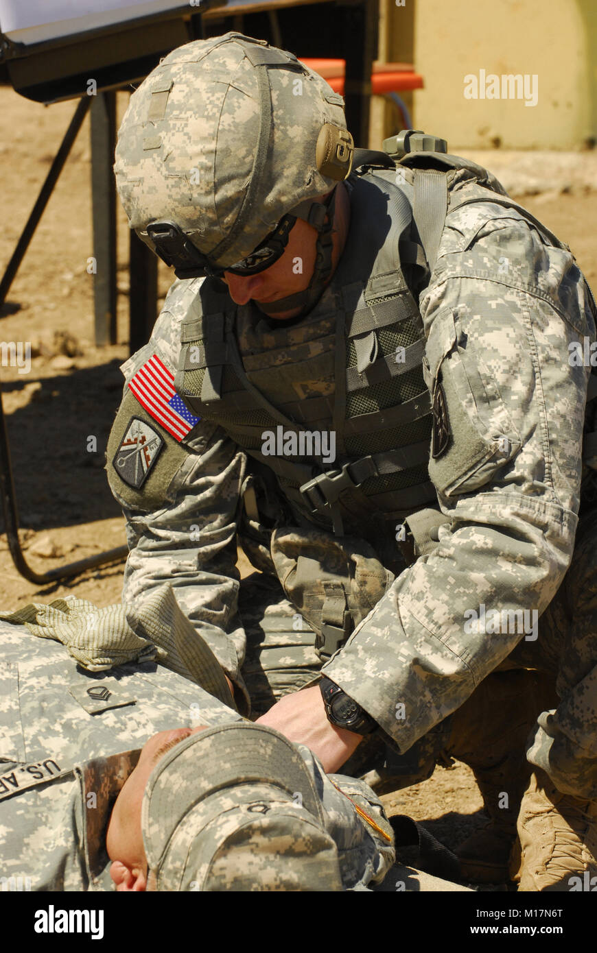 Guarding First Aid 100913-A-2426L-006 A Soldier performs first aid on an injured role ...
