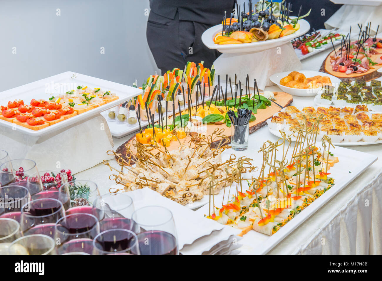 Catering table with food dishes, snacks and alcoholic and Catering table with food dishes, snacks and alcoholic and