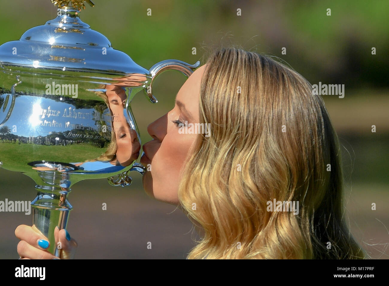 Melbourne, Australia. 28th Jan, 2018. The 2018 Australian Open Women's Champion Caroline Wozniacki of Denmark kisses her trophy at the Botanical Gardens in Melbourne, Australia. Sydney Low/Cal Sport Media/Alamy Live News Stock Photo