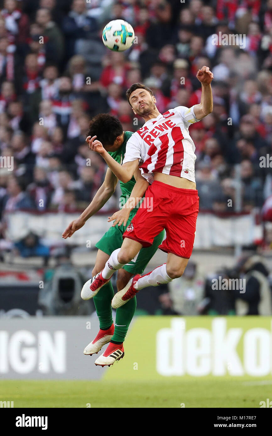 Colonge, Germany. 27th Jan, 2018. Koo Ja Cheol (L) of Augsburg vies with Jonas Hector of Colonge during the German Bundesliga match between 1. FC Colonge and FC Augsburg, in Colonge, Germany, January 27, 2018. The match ended with a 1-1 draw. Credit: Ulrich Hufnagel/Xinhua/Alamy Live News Stock Photo