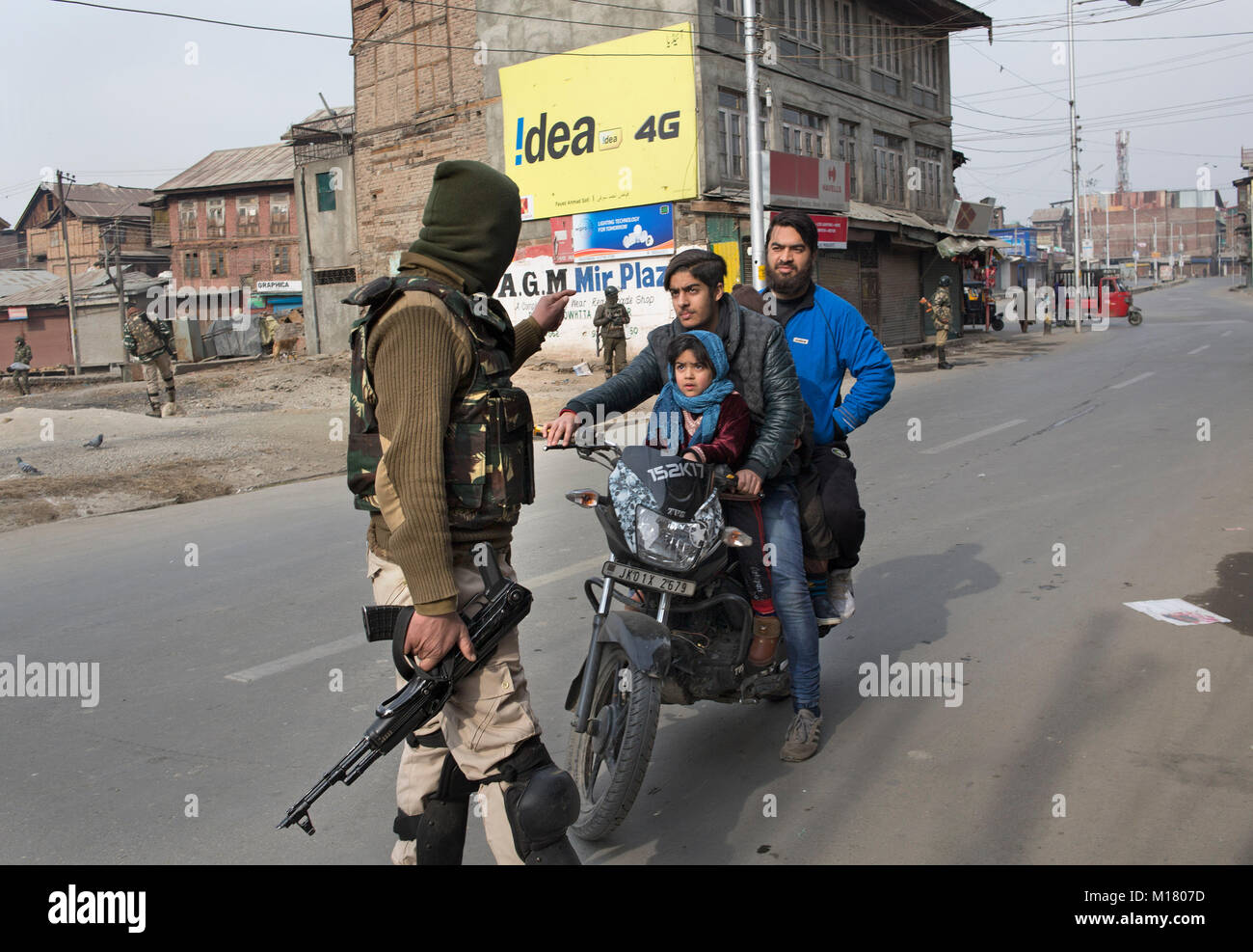 Srinagar, Indian-controlled Kashmir. 28th Jan, 2018. An Indian paramilitary trooper stops a motorcyclist during restrictions to prevent protests against civilian killings, in Srinagar city, the summer capital of Indian-controlled Kashmir, Jan. 28, 2018. At least two civilians were killed and one wounded Saturday after Indian troops fired upon protesters in restive Indian-controlled Kashmir, police said. Credit: Javed Dar/Xinhua/Alamy Live News Stock Photo