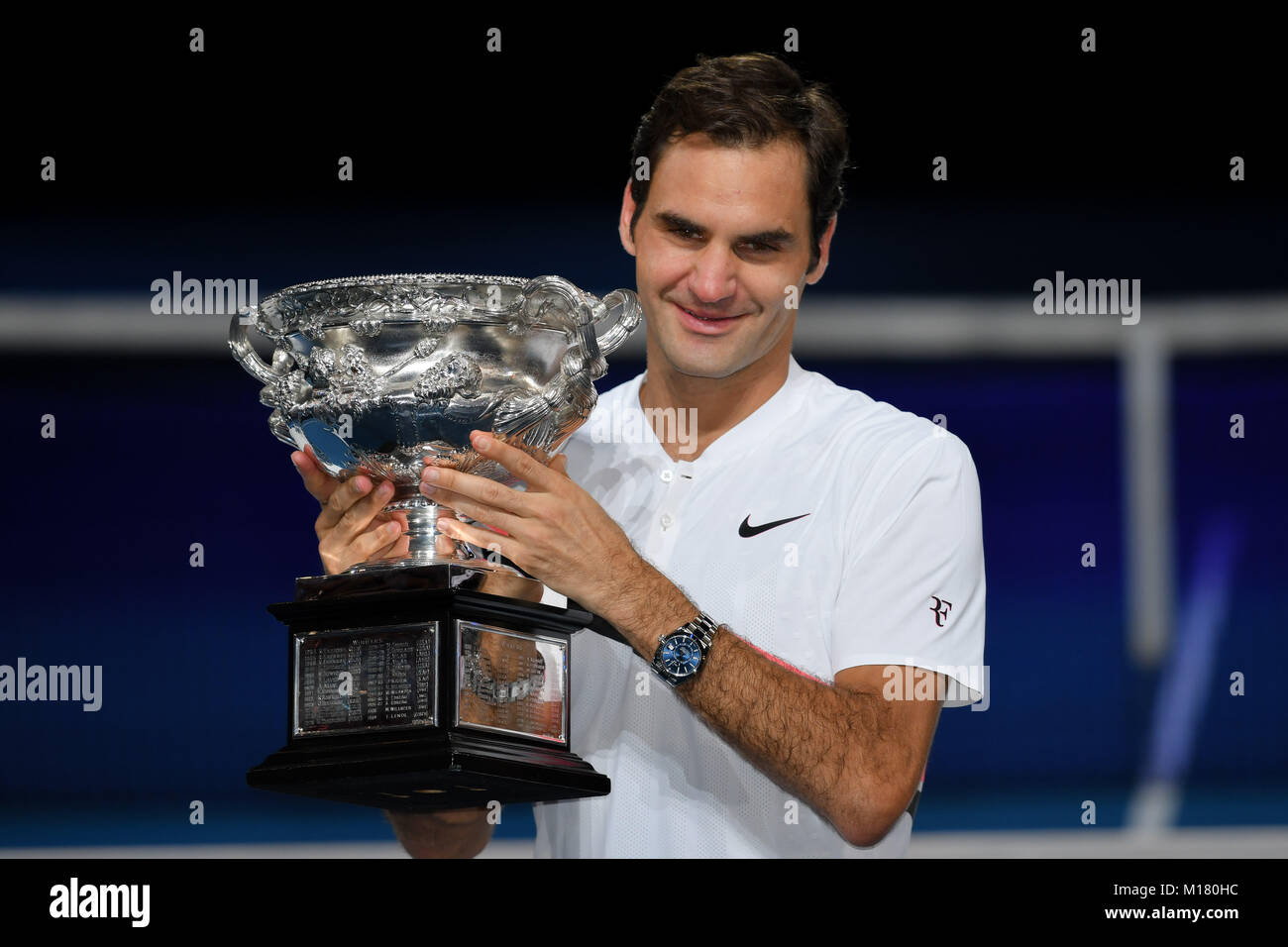 Melbourne, Australia. 28th Jan, 2018. Number two seed Roger Federer of Switzerland poses for photographs with the trophy after winning the Men's Final against number six seed Marin Cilic of Croatia on day fourteen of the 2018 Australian Open Grand Slam tennis tournament in Melbourne, Australia. Federer won 3 sets to 2. Sydney Low/Cal Sport Media/Alamy Live News Stock Photo