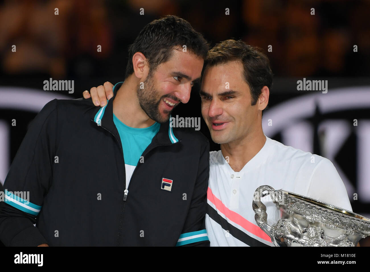 Melbourne, Australia. 28th Jan, 2018. Number two seed Roger Federer of Switzerland and number six seed Marin Cilic of Croatia share a moment during the presentation of trophies after Federer won the Men's Final against on day fourteen of the 2018 Australian Open Grand Slam tennis tournament in Melbourne, Australia. Federer won 3 sets to 2. Sydney Low/Cal Sport Media/Alamy Live News Stock Photo