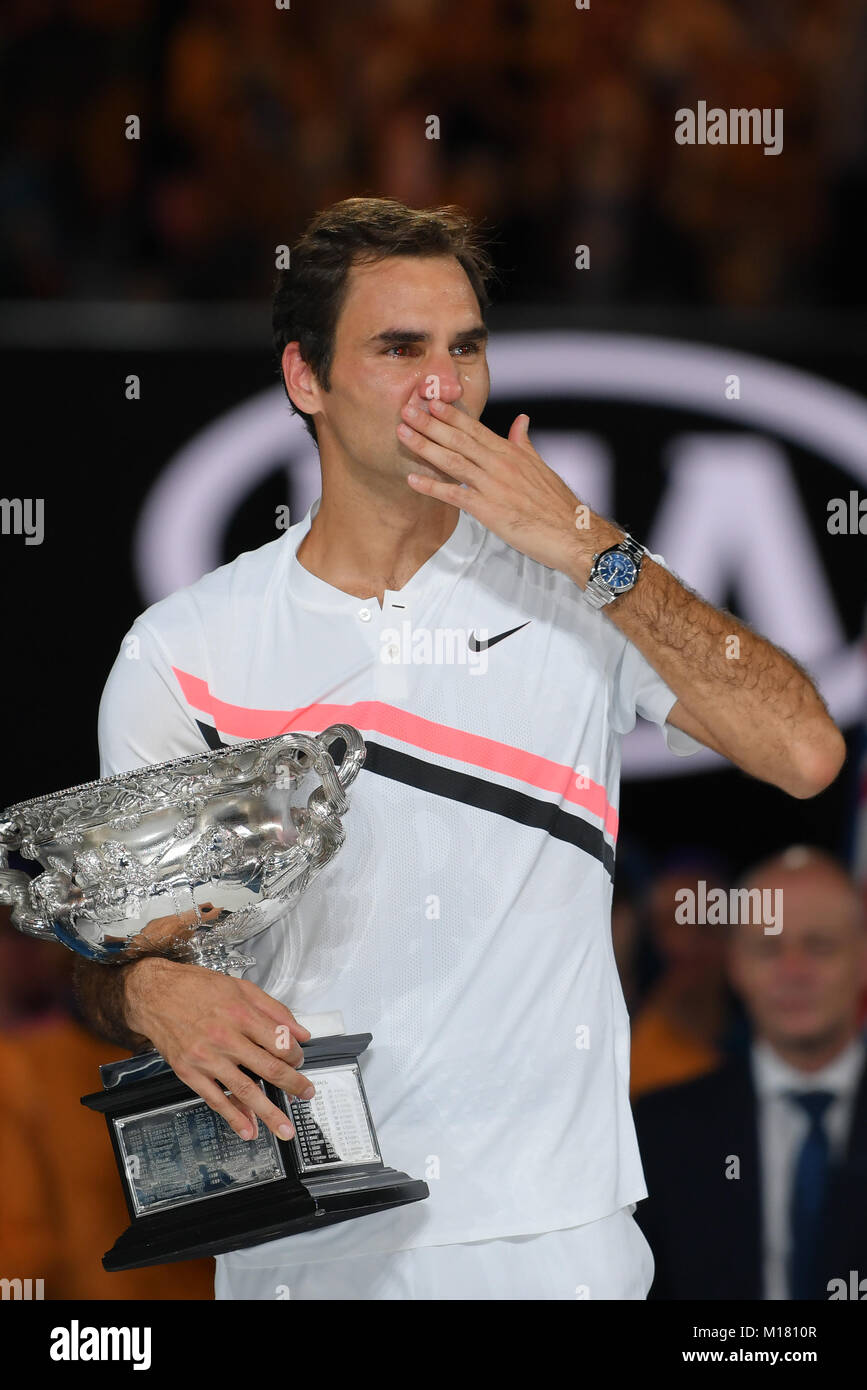 Melbourne, Australia. 28th Jan, 2018. Number two seed Roger Federer of Switzerland poses for photographs with the trophy and sheds a tear after winning the Men's Final against number six seed Marin Cilic of Croatia on day fourteen of the 2018 Australian Open Grand Slam tennis tournament in Melbourne, Australia. Federer won 3 sets to 2. Sydney Low/Cal Sport Media/Alamy Live News Stock Photo