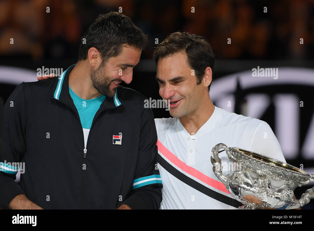 Melbourne, Australia. 28th Jan, 2018. Number two seed Roger Federer of Switzerland and number six seed Marin Cilic of Croatia share a moment during the presentation of trophies after Federer won the Men's Final against on day fourteen of the 2018 Australian Open Grand Slam tennis tournament in Melbourne, Australia. Federer won 3 sets to 2. Sydney Low/Cal Sport Media/Alamy Live News Stock Photo