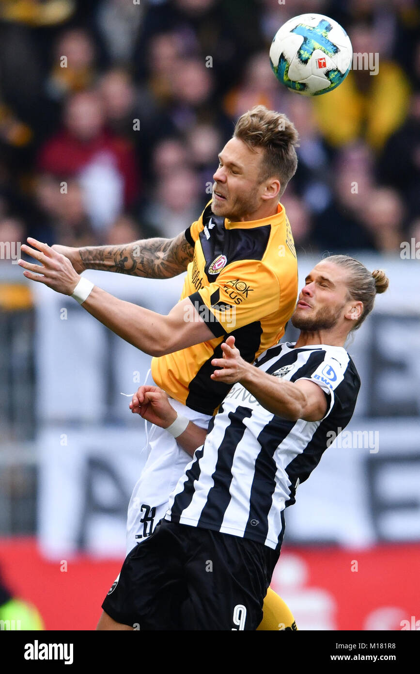 Sandhausen, Germany. 28th Jan, 2018. Sandhausen's Rurik Gislason (R) and Dresden's Marcel Franke vie for the ball during the German 2nd Budesliga match between SV Sandhausen and Dynamo Dresden at the Hardtwald Stadium in Sandhausen, Germany, 28 January 2018. (EMBARGO CONDITIONS - ATTENTION: Due to the accreditation guidelines, the DFL only permits the publication and utilisation of up to 15 pictures per match on the internet and in online media during the match.) Credit: Uwe Anspach/dpa/Alamy Live News Stock Photo