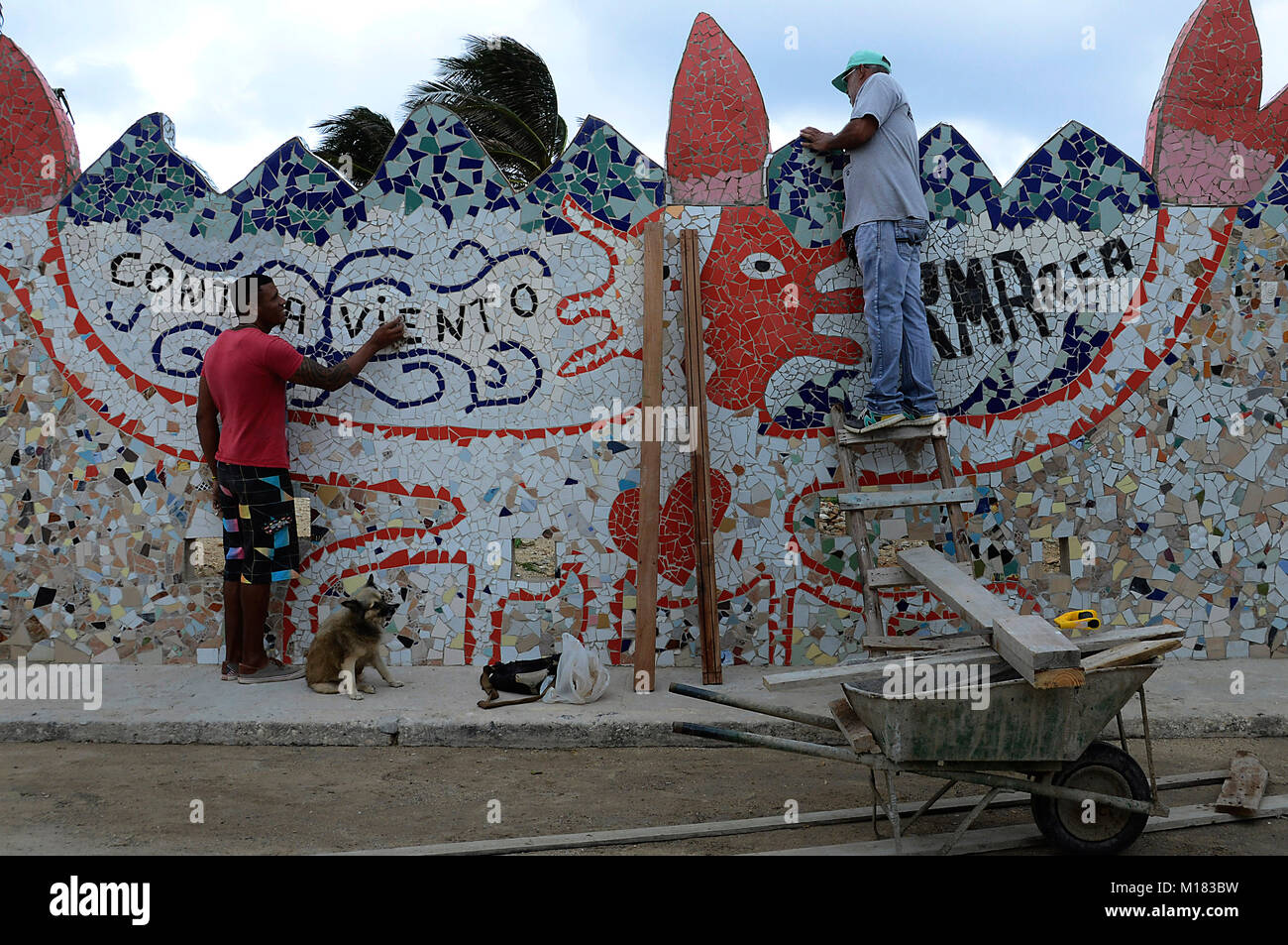 (180129) -- HAVANA, Jan. 29, 2018 (Xinhua) -- Workers clean a facade benefited by the community cultural project 'The Joy of Living' headed by the Cuban painter and sculptor Jose Antonio Rodriguez Fuster, in Jaimanitas of Havana, Cuba, on Jan. 25, 2018. Fusterland, a humble neighborhood to the west of Havana transformed from a remote fishing village, has become a hot tourist attraction in recent years thanks to the transformation, and the key to the fundamental change is, to the shock of many, art. Jaimanitas, or what many people call 'Fusterland,' owns its unusual popularity to Cuban painter  Stock Photo