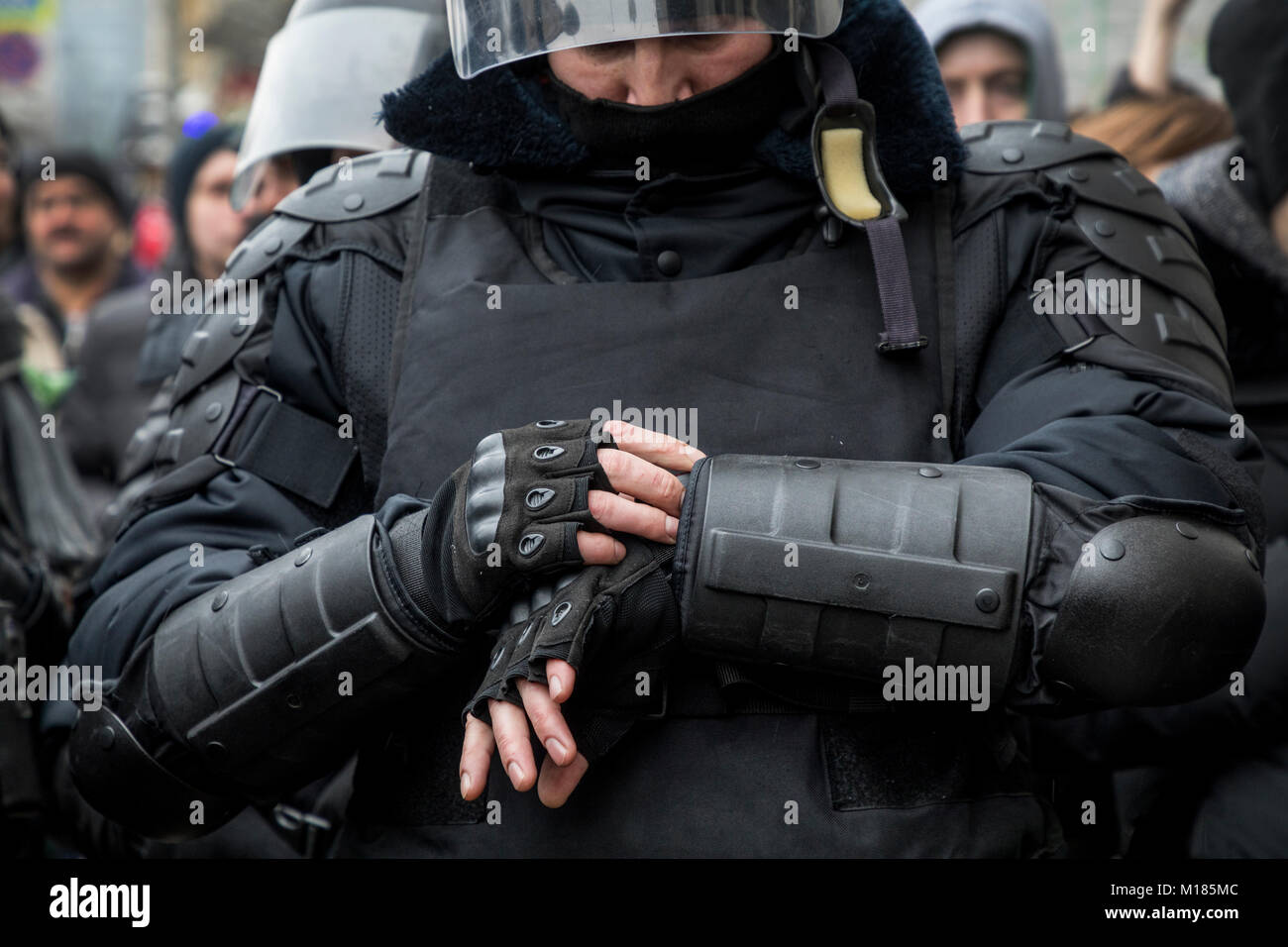 Moscow, Russia. 28th Jan, 2018. A policeman looks at his watch during an opposition rally calling for a boycott of March 18 presidential elections, in Moscow, Russia Credit: Nikolay Vinokurov/Alamy Live News Stock Photo