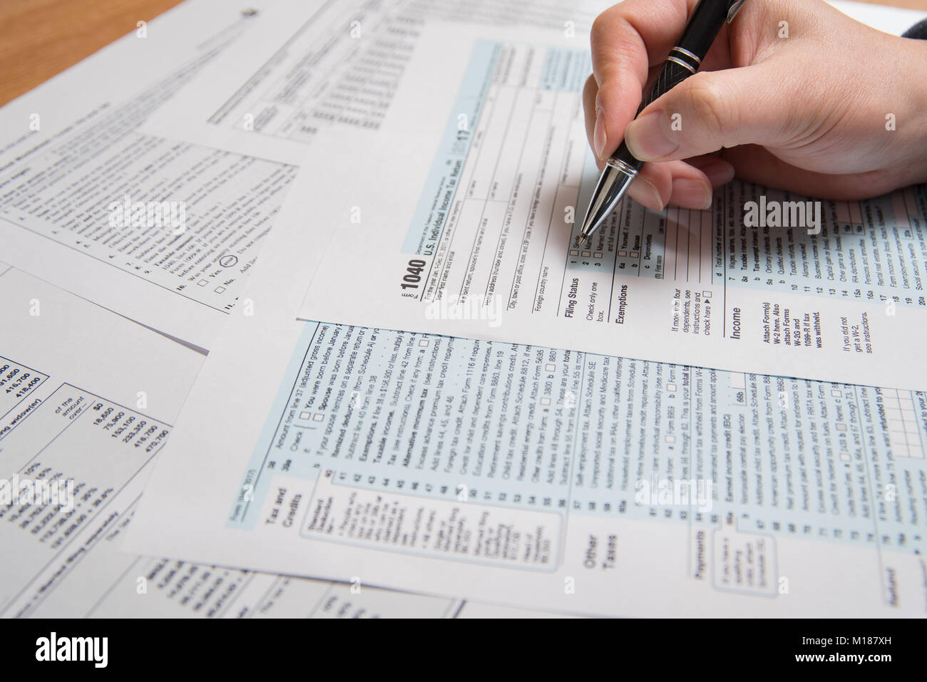 USA tax form 1040. Man filling US tax form. Stock Photo