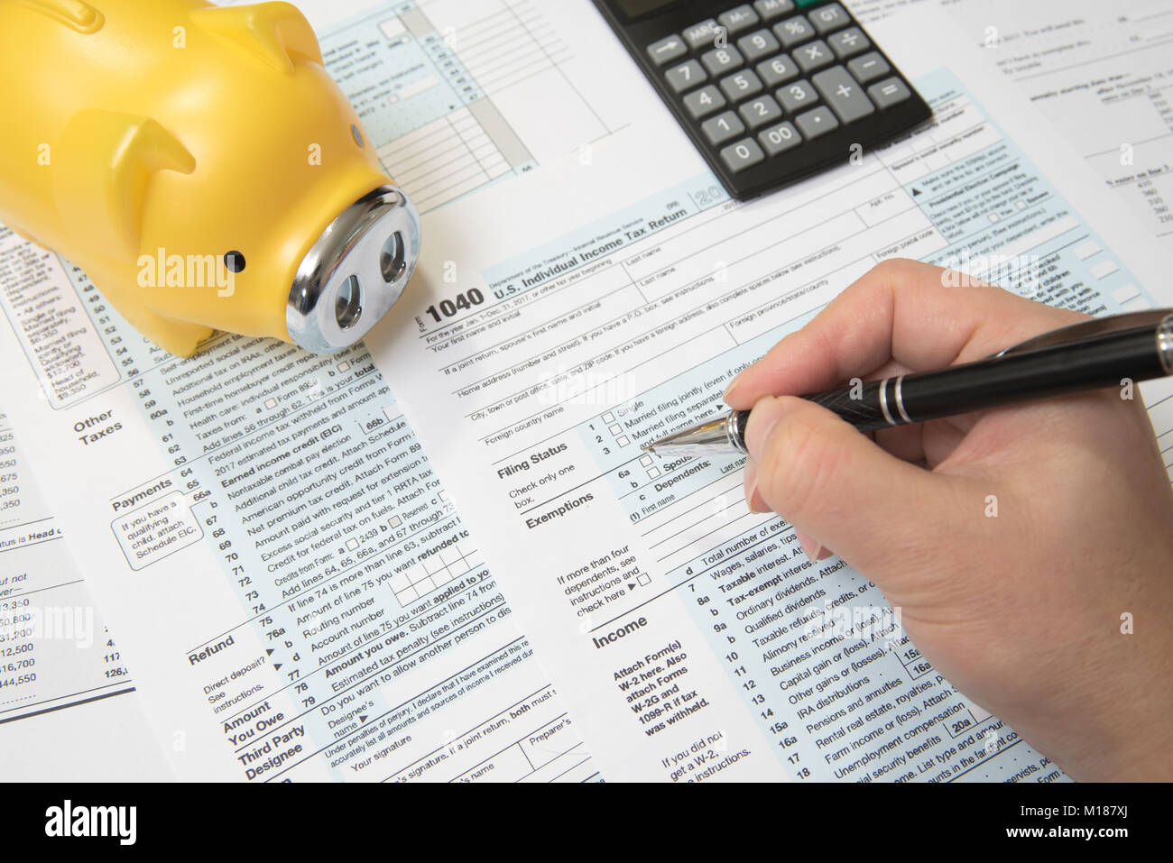 USA tax form 1040 with Piggy Bank, Calculator, Pen Stock Photo
