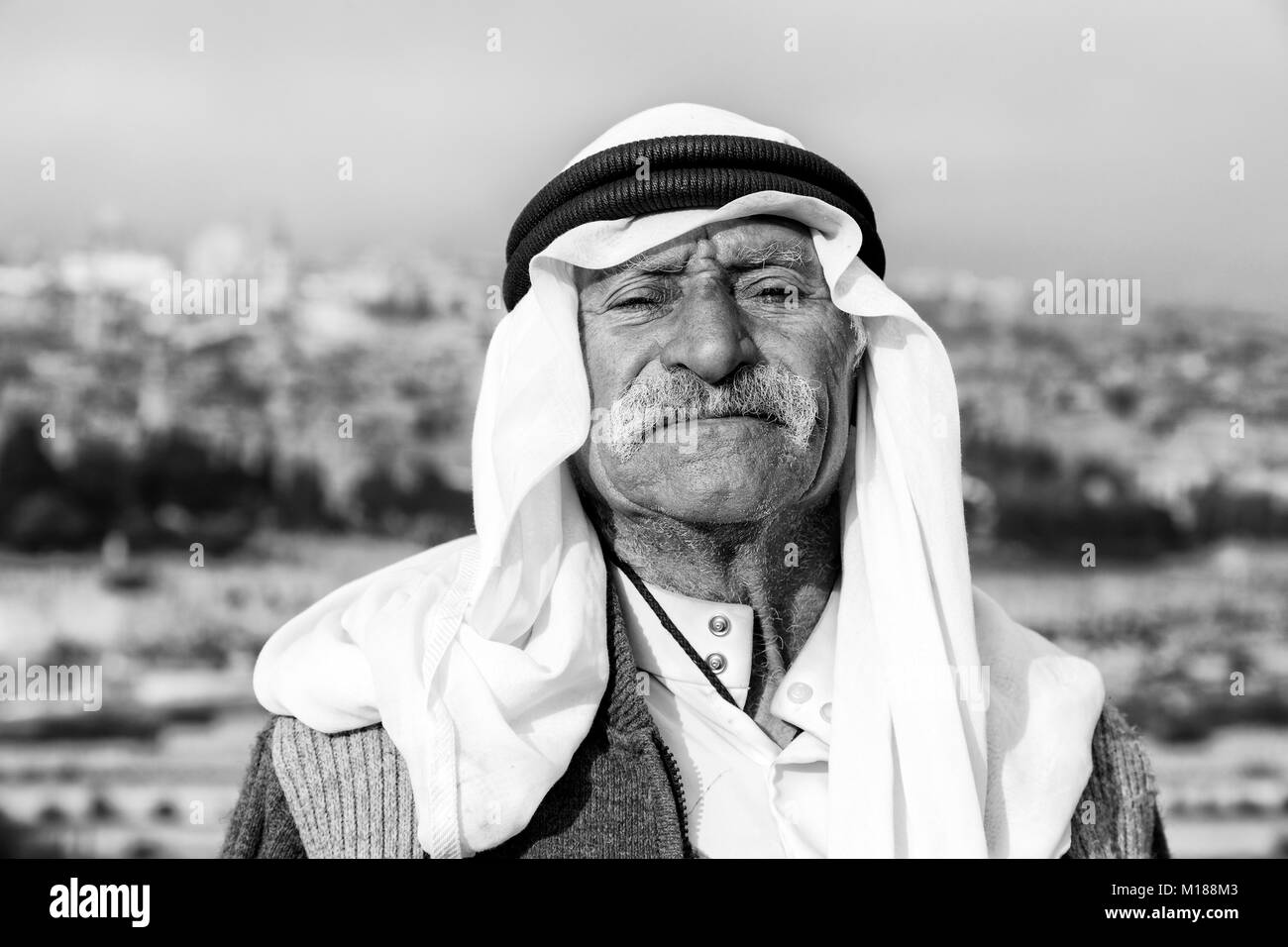 JERUSALEM, ISRAEL - December 2016: Arab man wave to peace against the Temple Mount and lift his arm Stock Photo