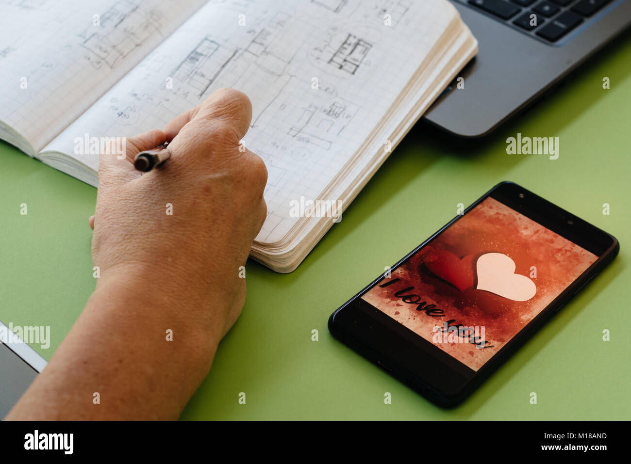 Valentines day sale background with heart illustration with the words I Love You on smartphone screen mockup on green background with architect woman  Stock Photo