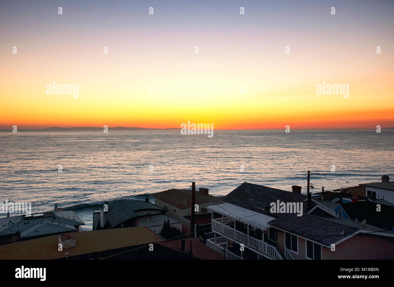 Expensive homes lining Laguna Beach California as the sun is setting