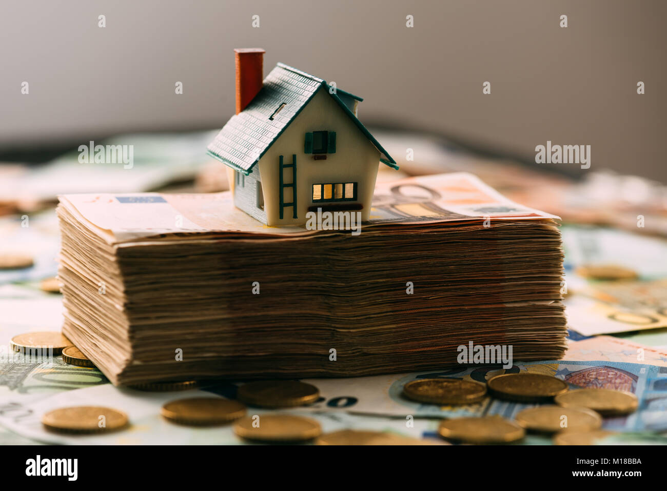 House model on cash stack closeup Stock Photo