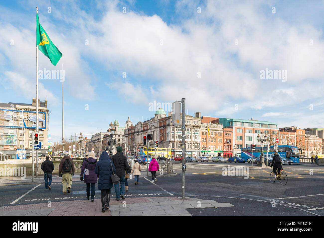 pedestrians crossing the road at O'Connell Bridge, Dublin facing towards O'Connell Street, Dublin, Ireland, Europe Stock Photo