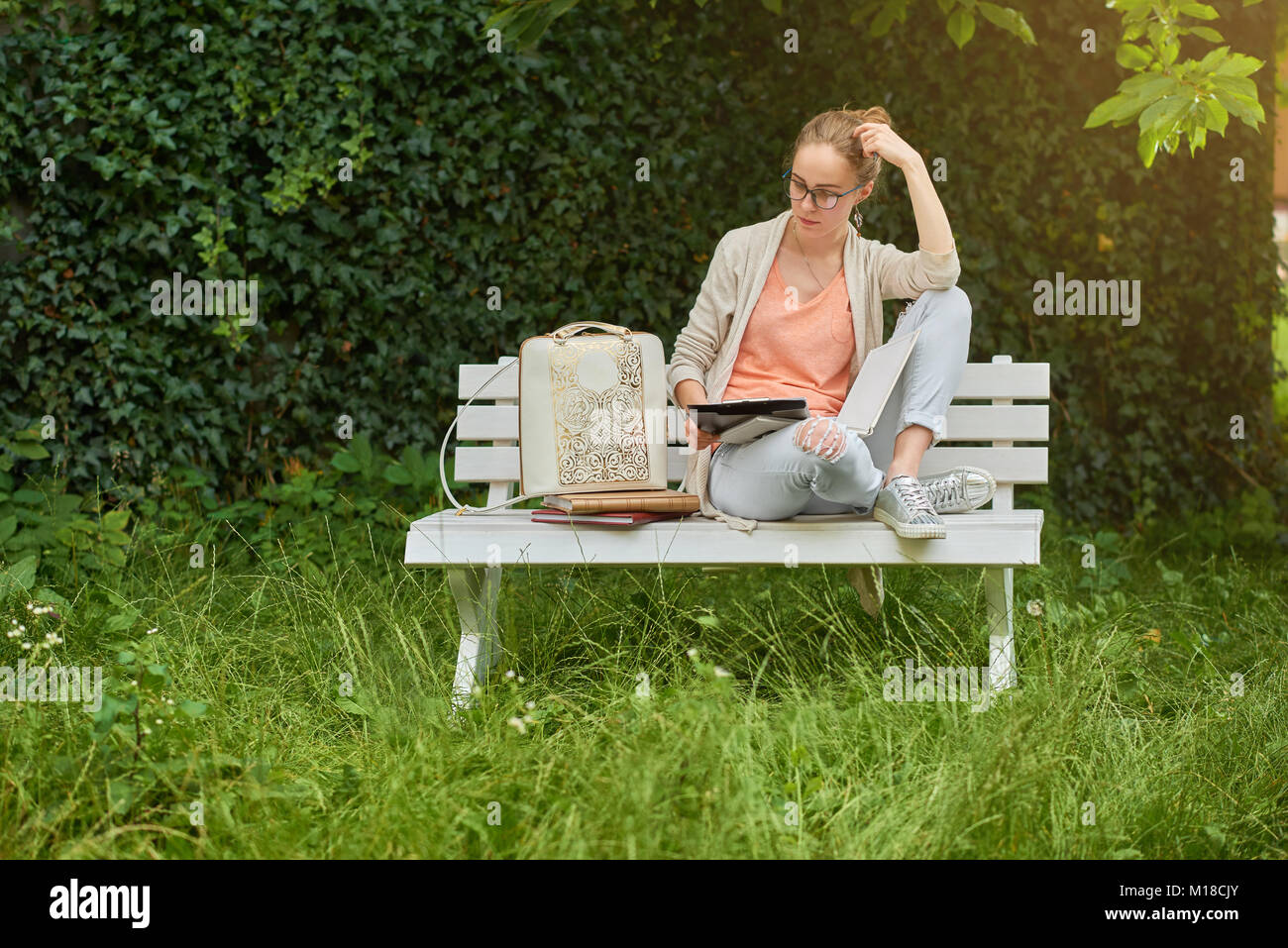 Close-up of a young girl studing in the park Stock Photo