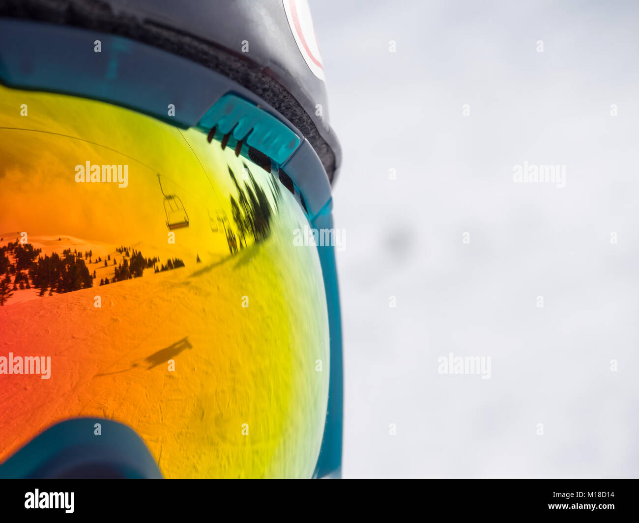 close up of colorfull googles that reflecting the landscape of a ski resort with lift Stock Photo