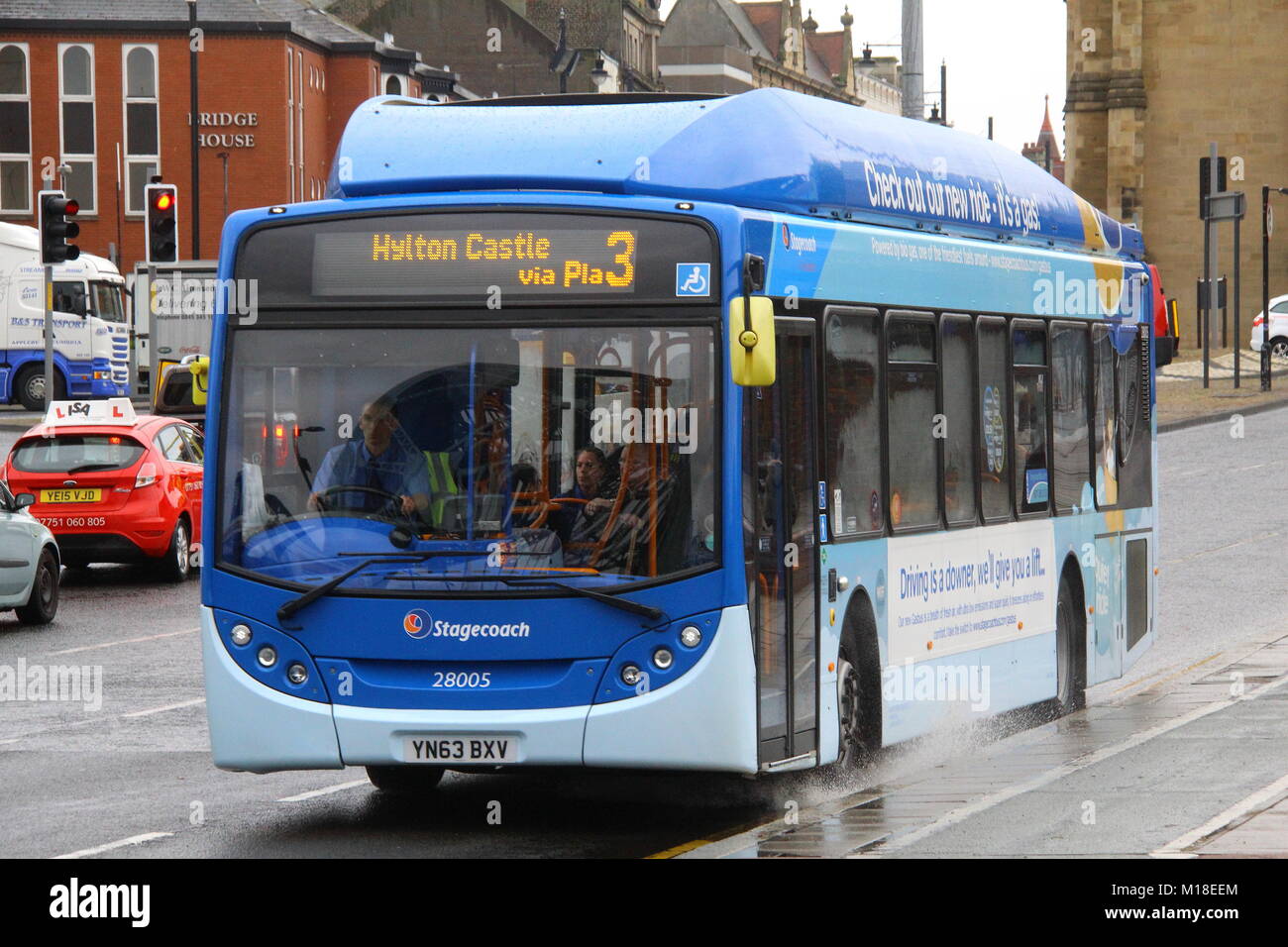 A SCANIA BUS WITH ADL ALEXANDER DENNIS ENVIRO 300 BODY POWERED BY GAS WORKING FOR STAGECOACH IN SUNDERLAND TRAVELLING IN THE RAIN ON A BUSY ROAD Stock Photo