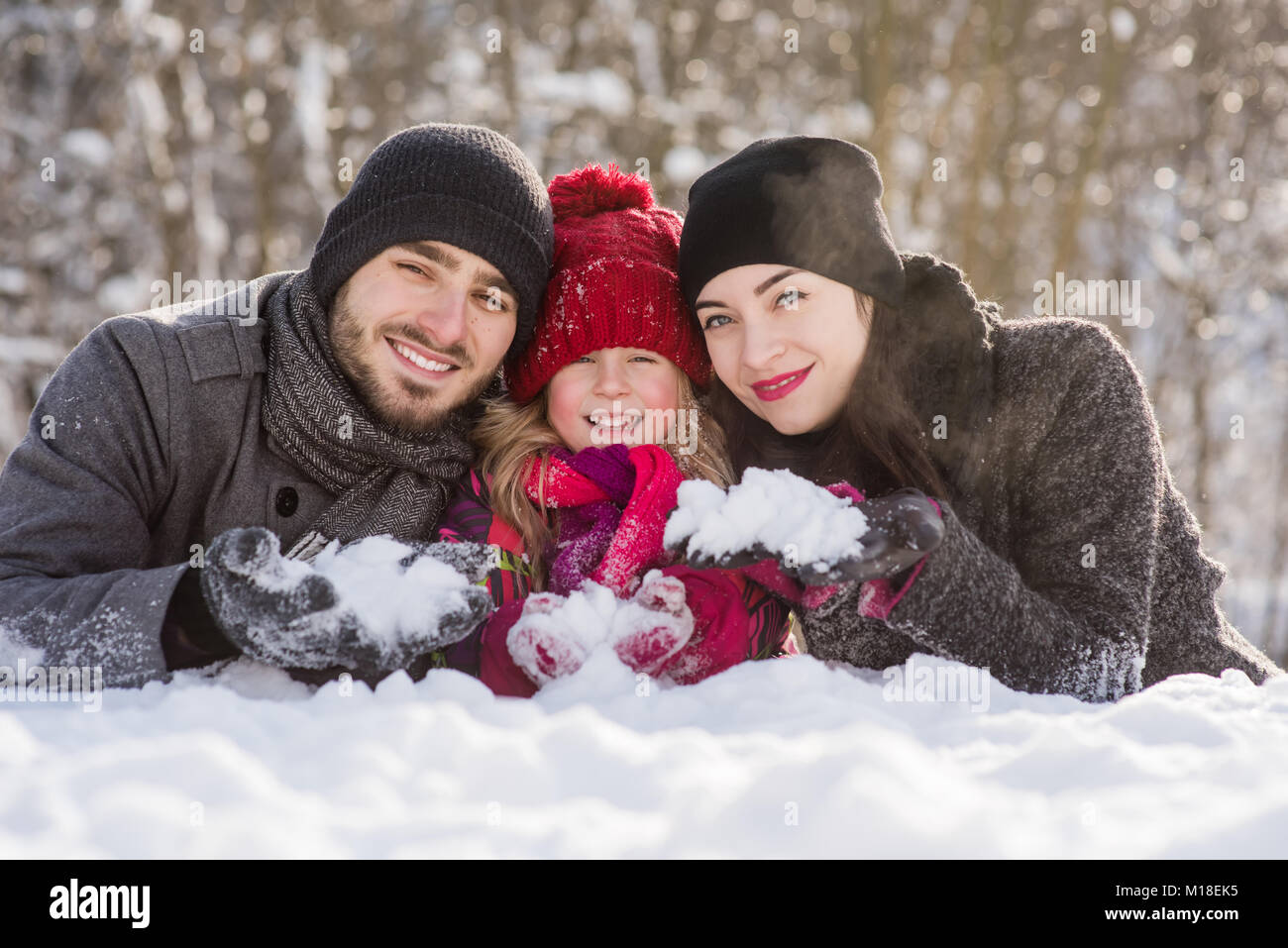 Happy family in winter background outdoors Stock Photo - Alamy