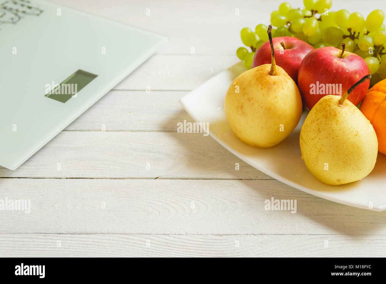 floor scale and fruits on wooden background Stock Photo
