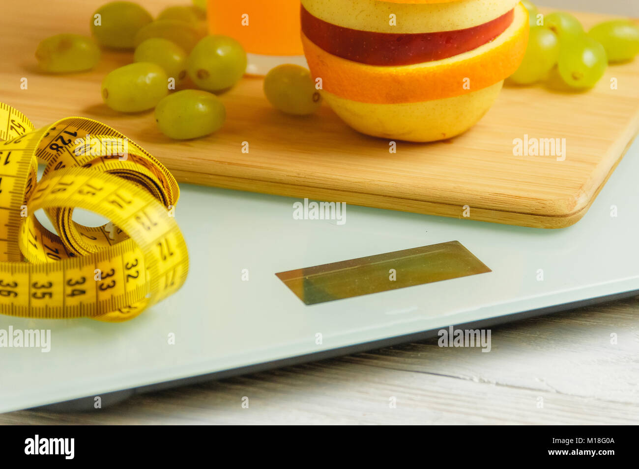 floor scale and fruits on wooden background Stock Photo