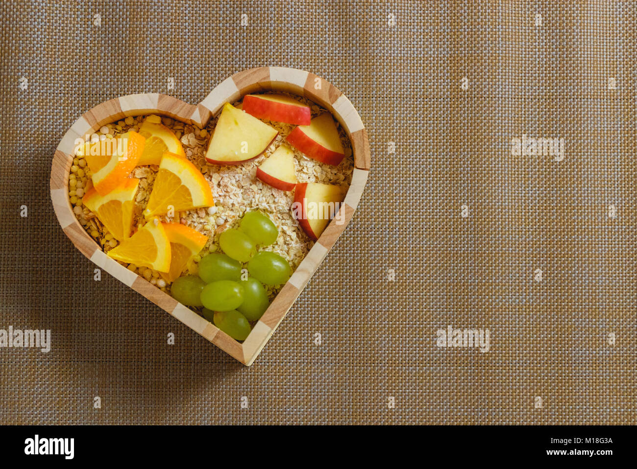 mixed fruits in heart shaped bowl. Healthy food concept Stock Photo