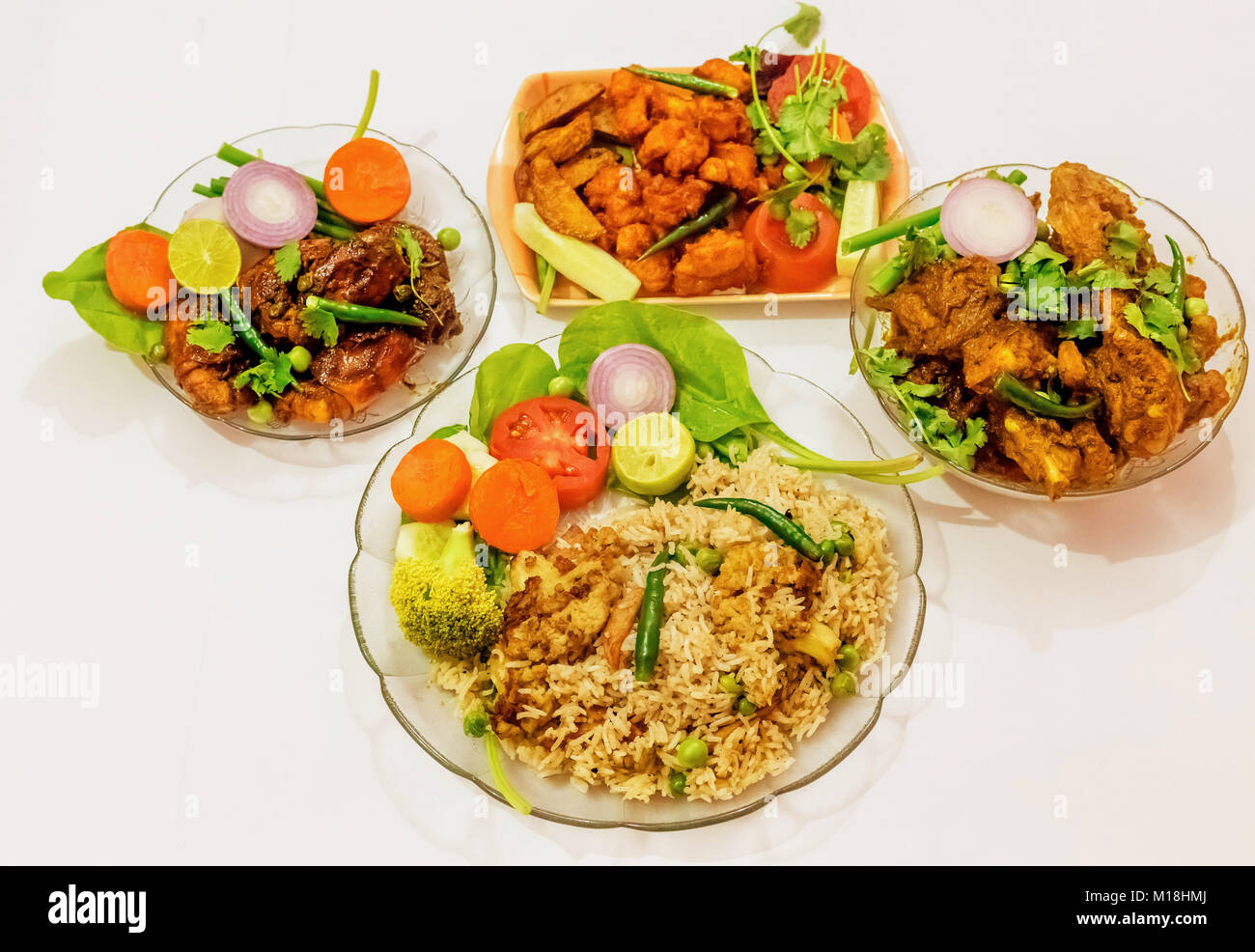 Spicy Indian non vegetarian food comprising of fried rice, deep fried spicy prawn, chicken boneless fry and chicken pakora. Stock Photo