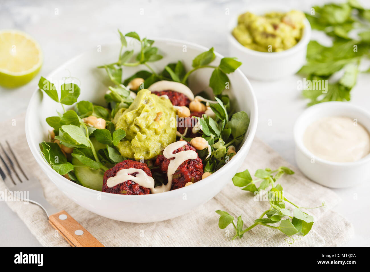 Green vegetable vegan salad with beets meatballs, Guacamole and tahini