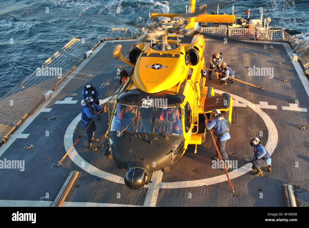 A helicopter crew from Coast Guard Air Station Cape Cod, in ...