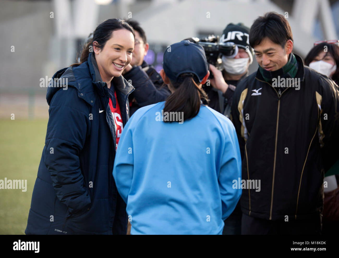 Valerie Arioto, an infielder with the U.S.A. National Women’s Softball team, speaks to a teenager from the Higashi Middle School softball team at the new Kizuna stadium in Iwakuni City, Japan, Jan. 25, 2018. The U.S.A National Women’s Softball team visited players from middle and elementary schools to practice together. The intent of the U.S. softball team’s visit was to determine if the stadium is suitable for the team to practice and play future games at. The stadium is a hallmark of what the U.S.-Japan friendship has accomplished in Iwakuni City. Everything from the dogwood trees planted ju Stock Photo