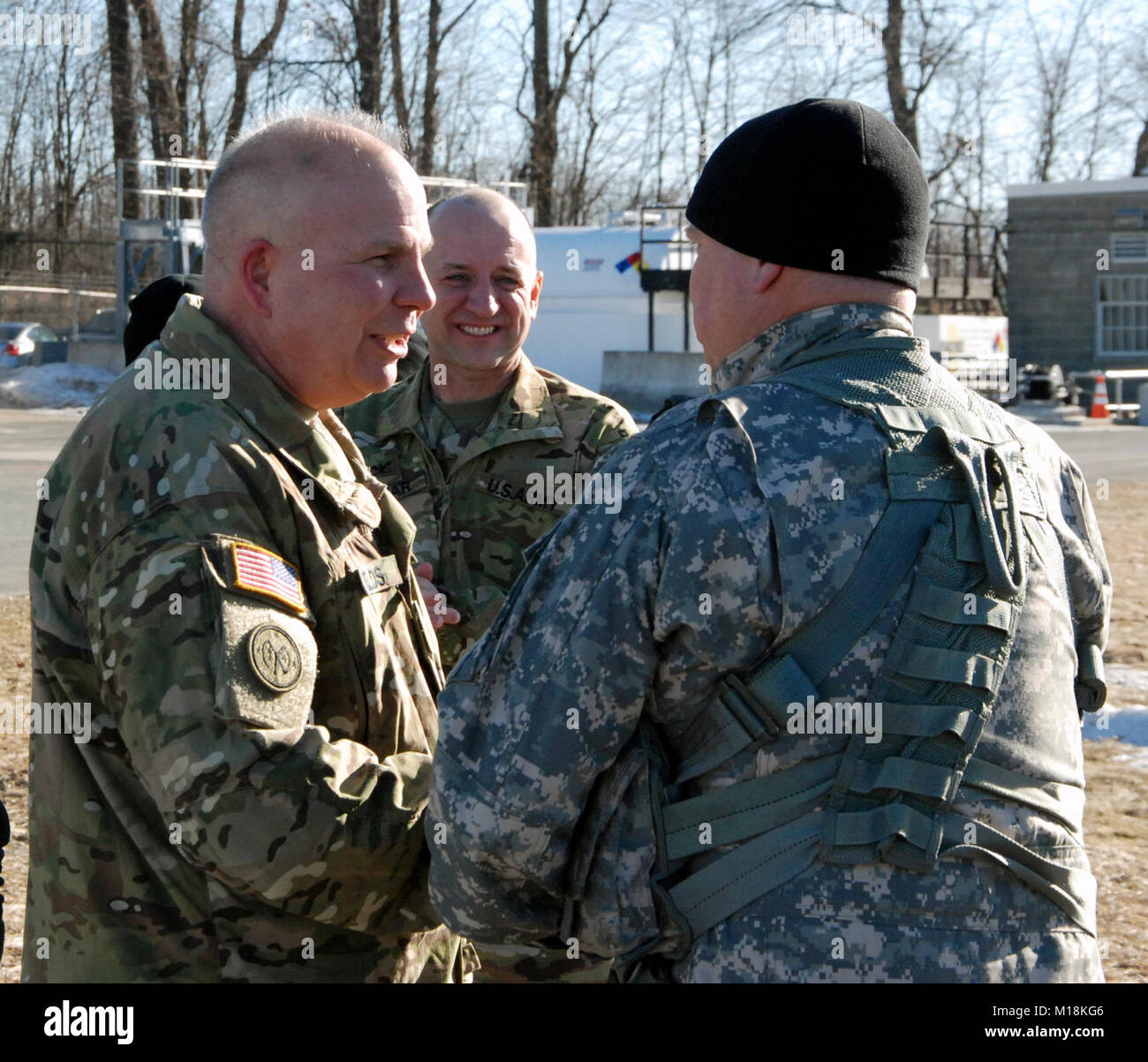 Major General Ray Shields (left), the commanderof the New York Army National Guard, congratulates Chief Warran Officer 5 Michael Johnson at the conclusion of his 'Final Flight' as an Army Pilot at Army Aviation Support Facility #3 in Latham, N.Y. on Jan. 25, 2018 as Col. Mark Slusar, the New York State Aviation Officer, looks on. Johnson celebrated his final flight after 35 years of service. ( U.S.Army National Guard Stock Photo