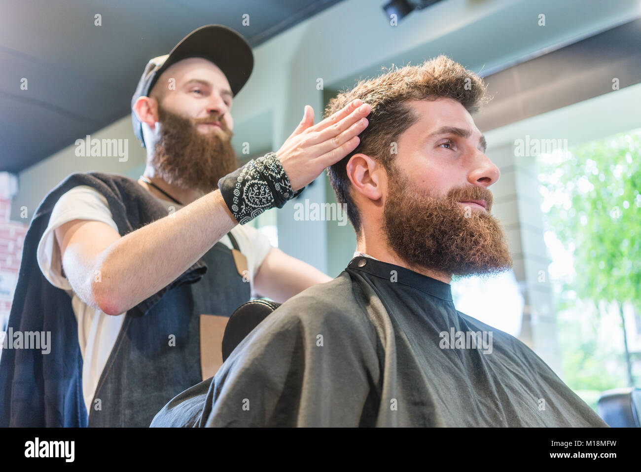 Handsome Bearded Young Man Ready For A Trendy Haircut In A Cool
