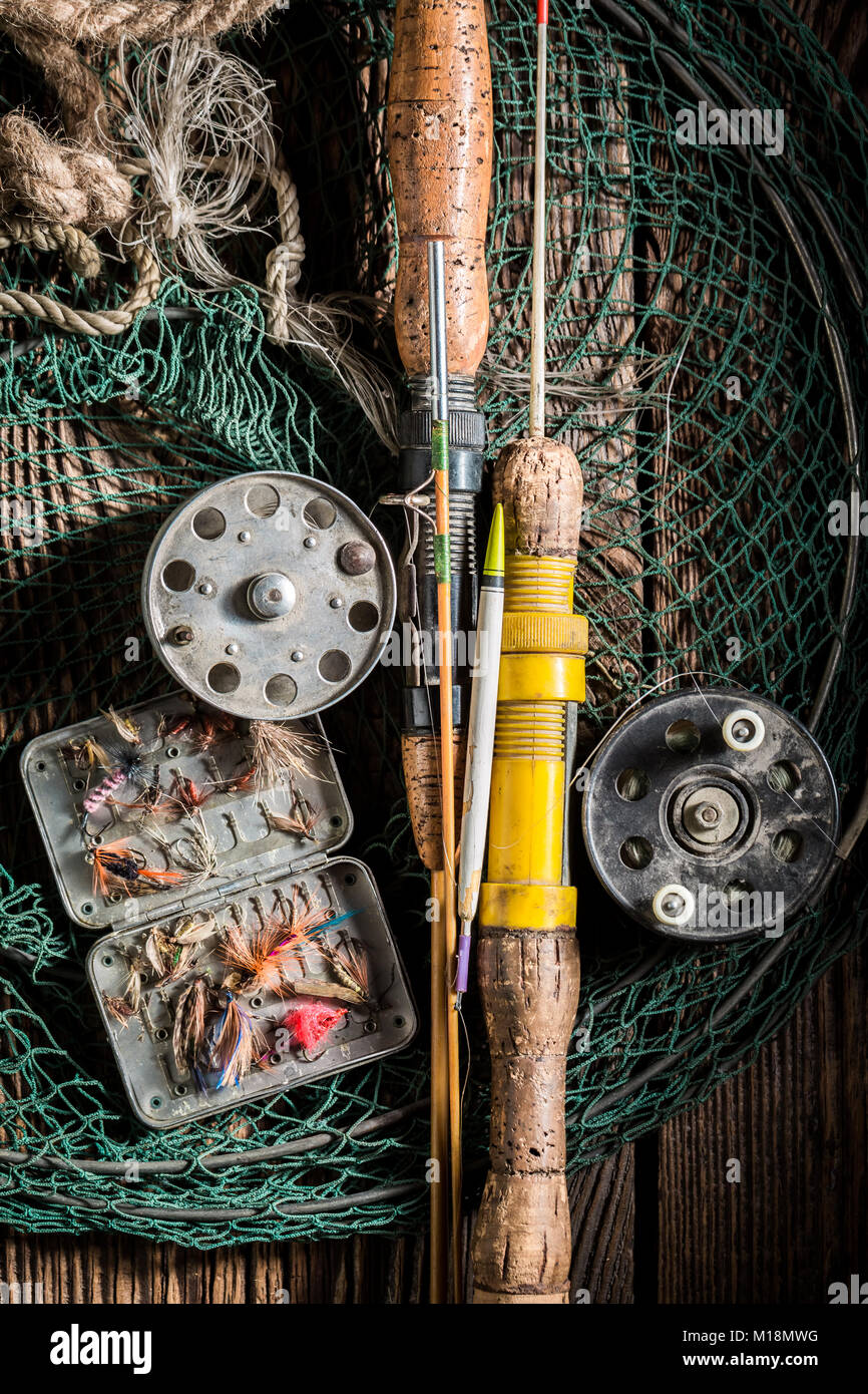 Three salmon flies that were probably homemade on the cork handle of an old fly  fishing rod resting on a whicker tackle box. From a collection of vint  Stock Photo - Alamy