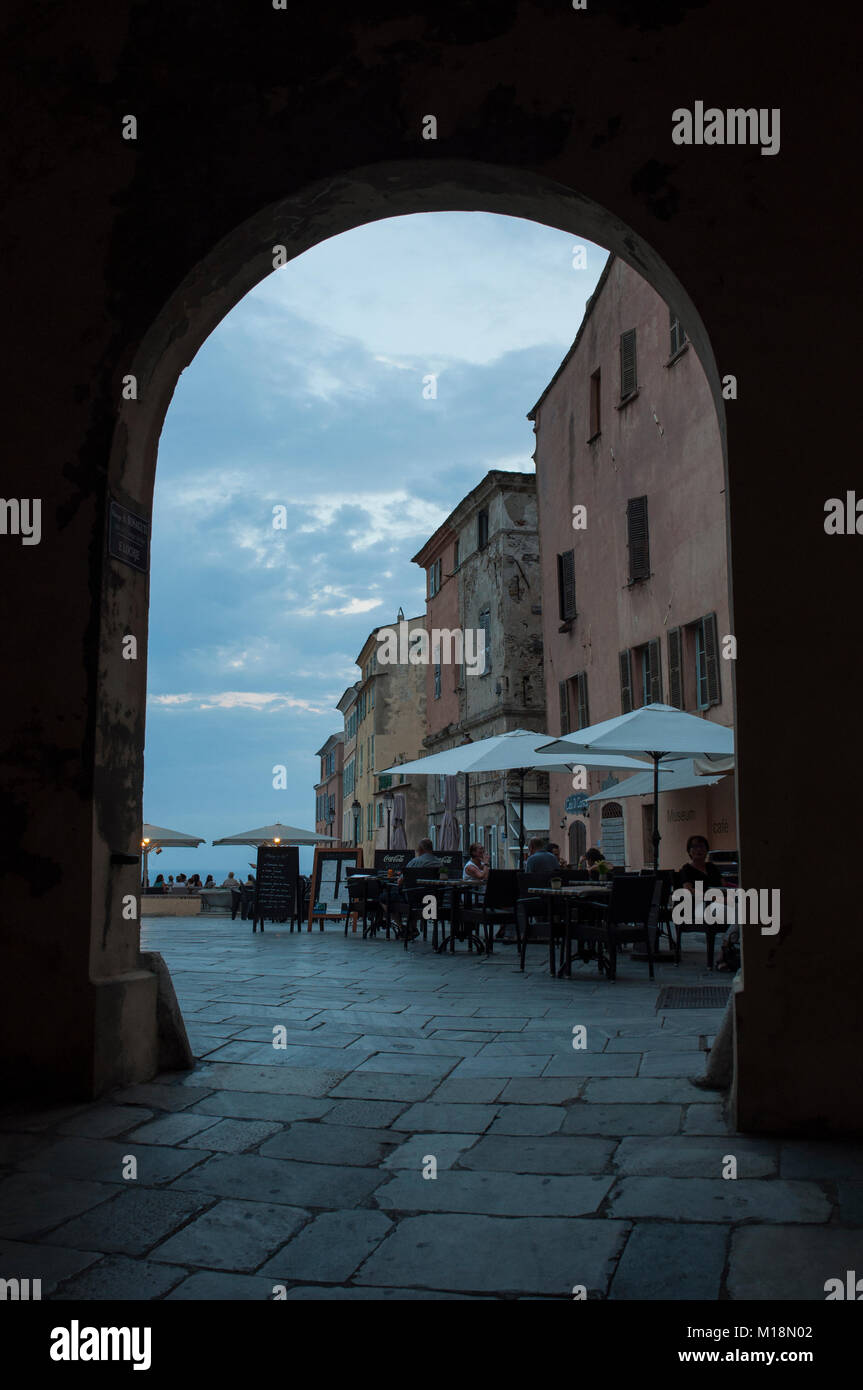 Corsica: an arch and the outdoor tables of the restaurants of the old Citadel of Bastia, the city in the northeast at the base of the Cap Corse Stock Photo
