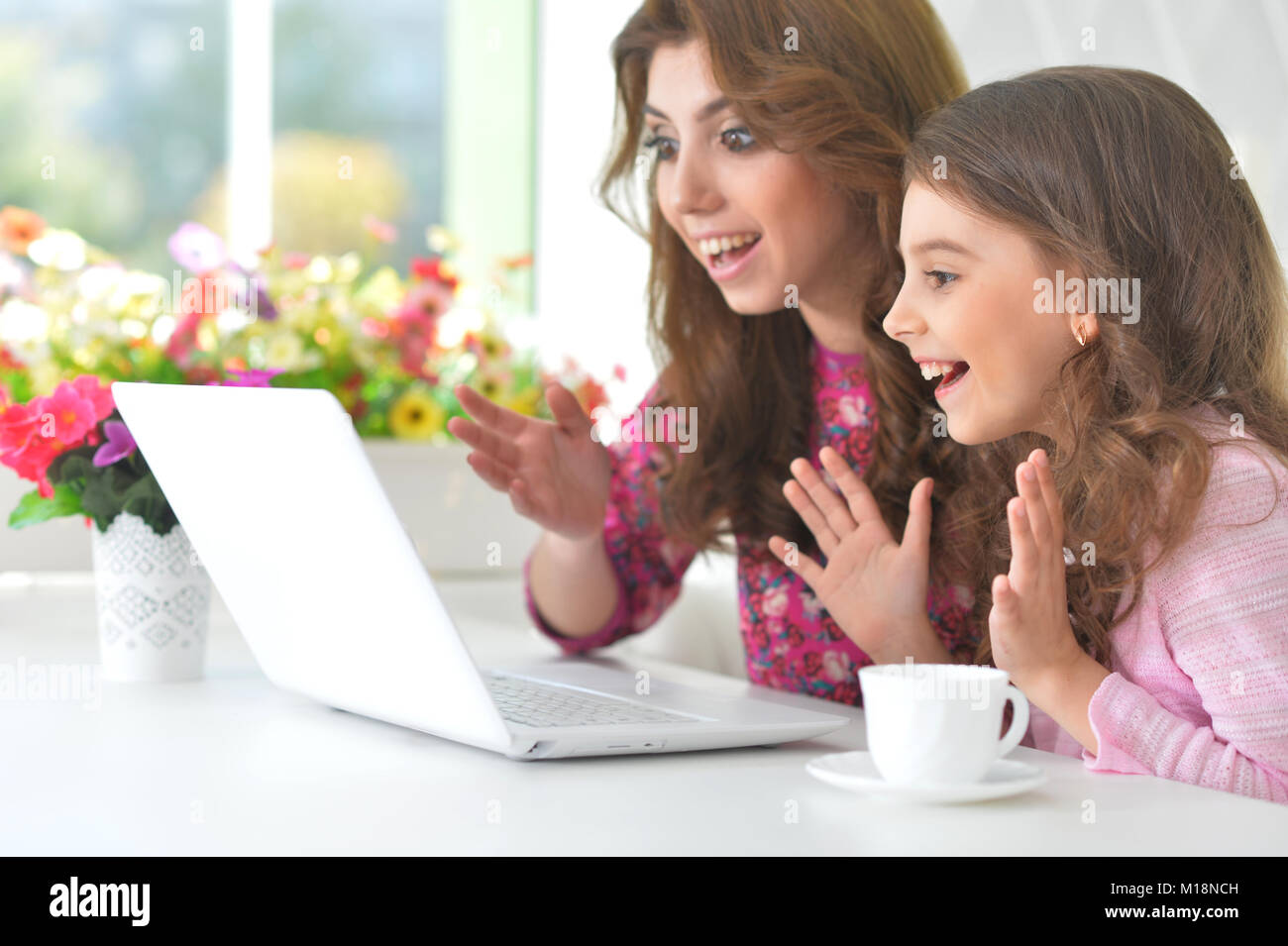 woman and little girl using laptop Stock Photo - Alamy